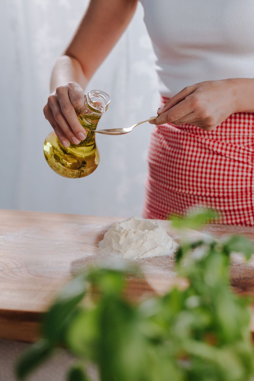 Handmade pasta and fresh olive oil on rustic Italian table